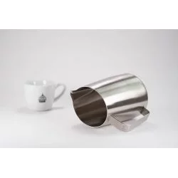 Symetrická konvička z nerezové oceli pro přípravu šlehání mléka o objemu 600ml na stole s bílým šálkem Lázeňské kávy
