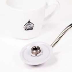 Klika šedé barvy ručního mlýnku Timemore C2 v bílé barvě a v pozadí porcelánový šálek s logem Lázeňské kávy