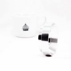 Stříbrný Filling funnel 53 mm položený na hranu na bílém pozadí s šálkem lázeňské kávy