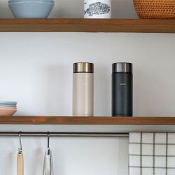 Termoláhev Hario Stick Bottle v ruce při nošení
